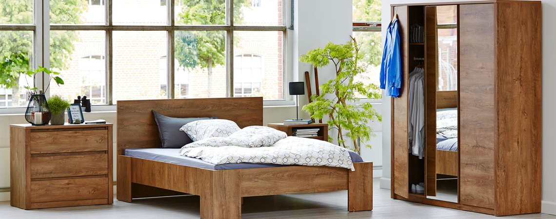 Try a dark wooden look with splashes of greenery in your bedroom bedroom furniture and design ideas