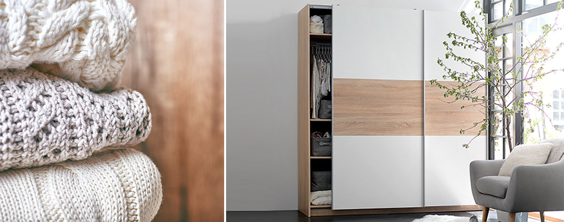 Stack of sweaters and wardrobe with sliding doors