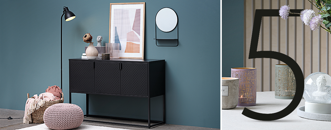 Console table surrounded by a pouffe, mirror, and floor lamp 