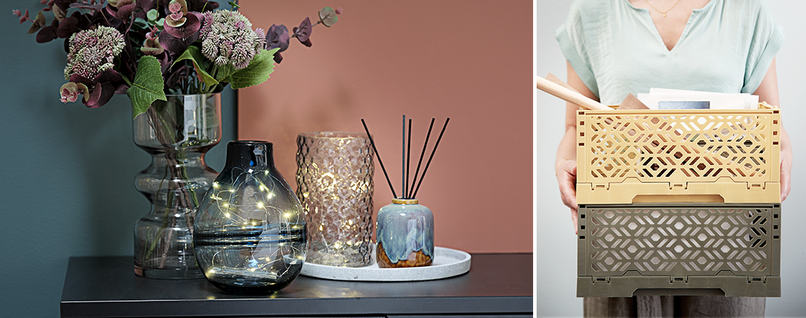 VICTOR, FOSS and MANFRED vase with string lights on VIRUM sideboard and woman carrying JARLE storage boxes Vases with string lights on a sideboard and woman carrying storage boxes