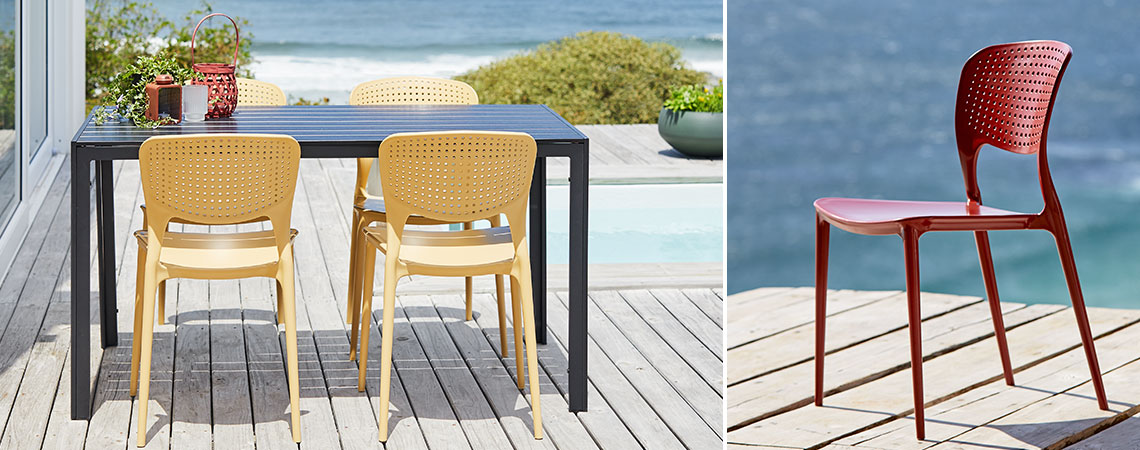 SEJLING chairs in yellow or red, also available in grey Garden set with chair in happy colours on a sunny patio by the ocean