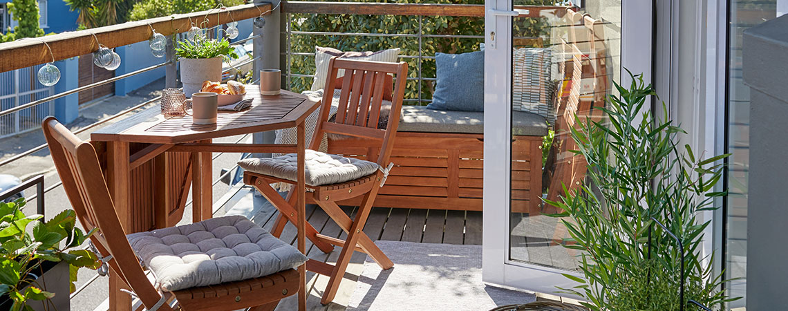 BEVTOFT folding table and VEN folding chairs with KARLBY storage box in the background Wooden garden bistro set and outside storage box on balcony