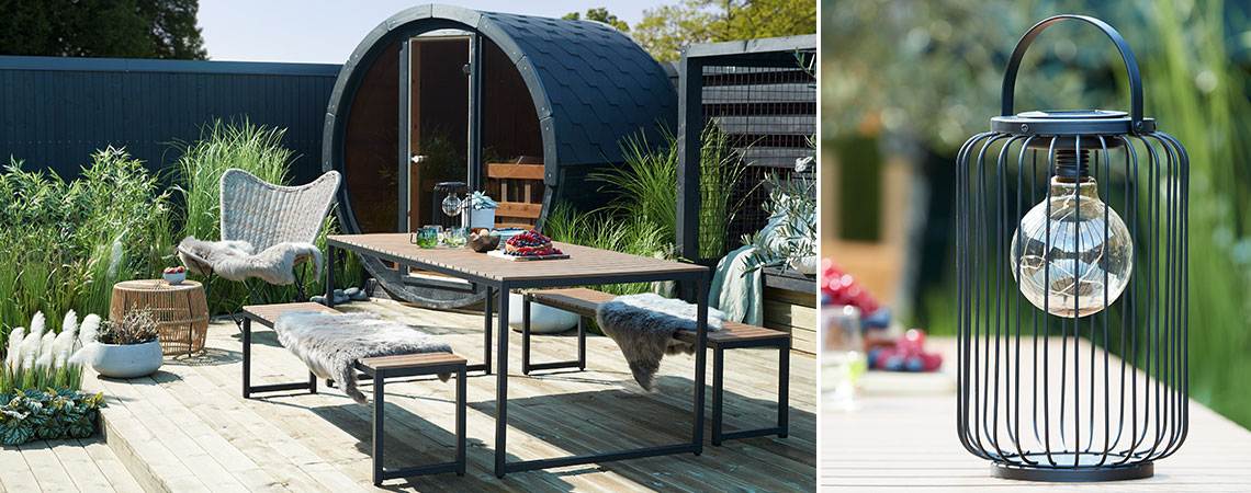 Garden table with a metal and wood garden bench on each side and a solar lamp