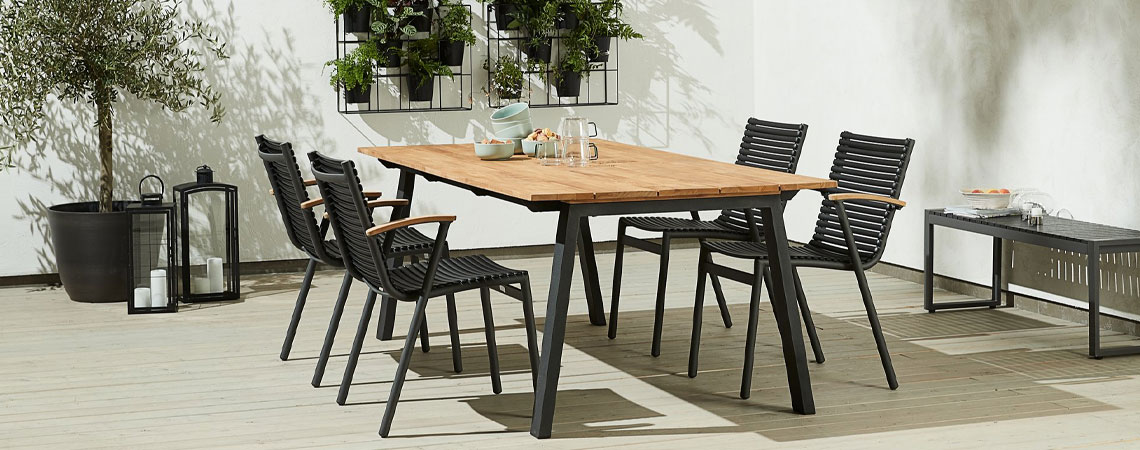 SADBJERG stacking chair with seat and backrest out of recycled ocean plastic and armrest out of FSC certified teak Garden stacking chairs with seat and backrest out of recycled ocean plastic