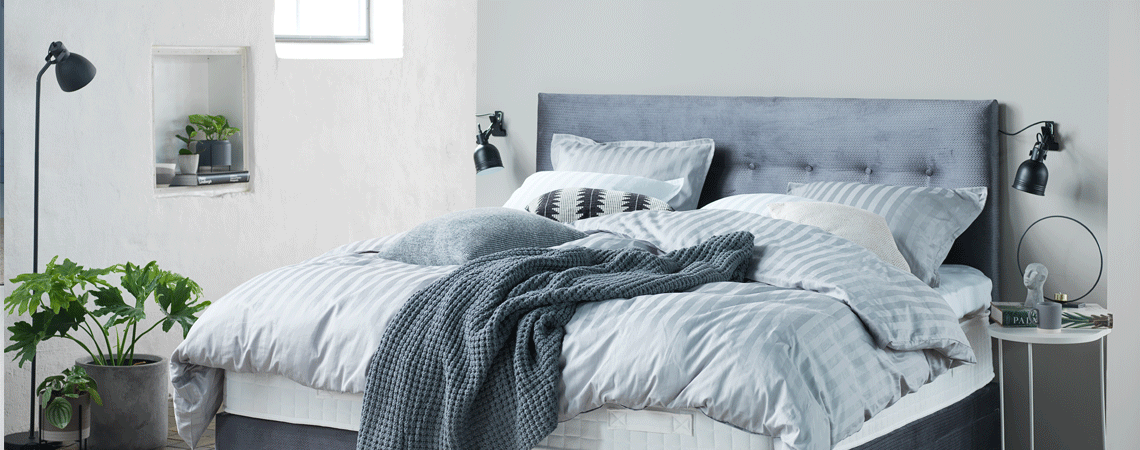 Learn about mattress prices Bedroom with bed, mattress, top mattress and light blue duvets and pillows
