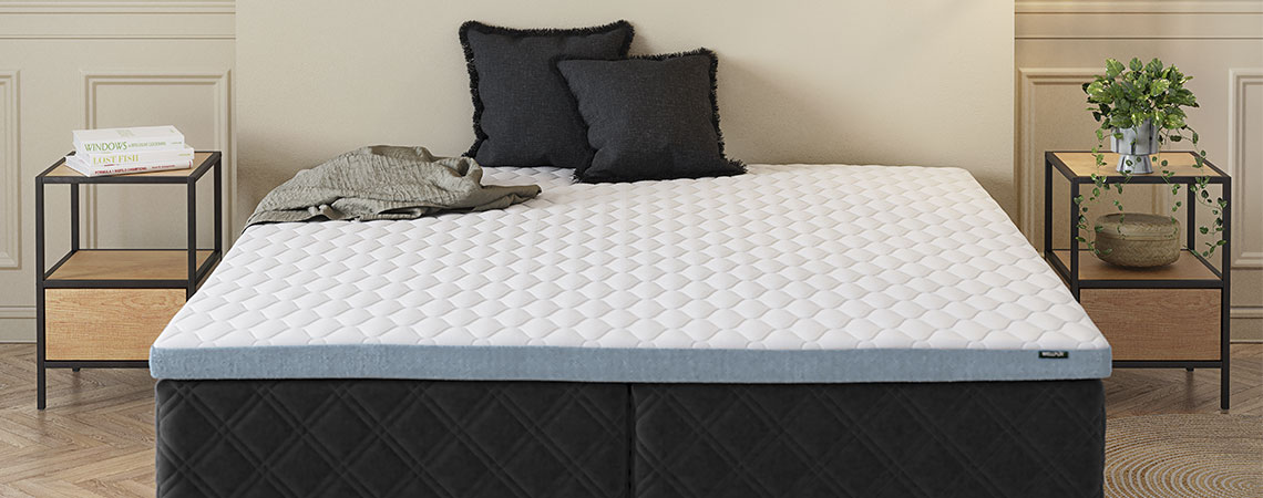 Bedroom with bed, mattress, top mattress and decorative cushions 
