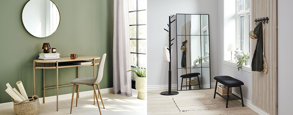 Round mirror above a desk and large mirror leaned against the wall in hallway