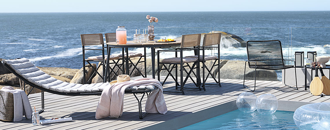 UBBERUP sun lounger, NAGELSTI chairs and BANDSBJERG lounge chairs Outdoor swimming pool with poolside lounge area