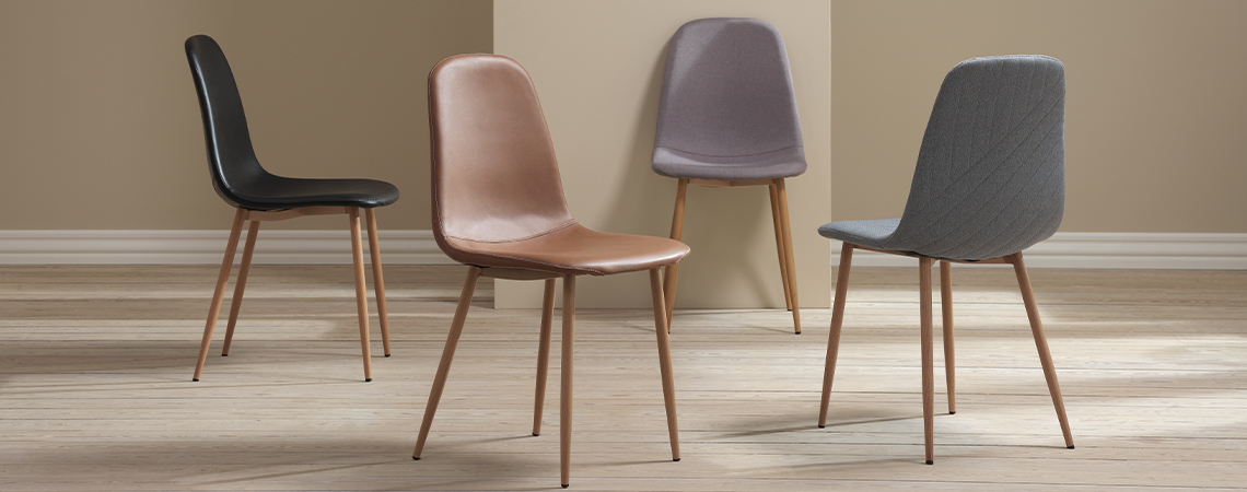 The JONSTRUP dining room chair comes in multiple colours and fabrics Shell chair type dining room chairs in black, grey, cognac, and light blue with oak-look legs