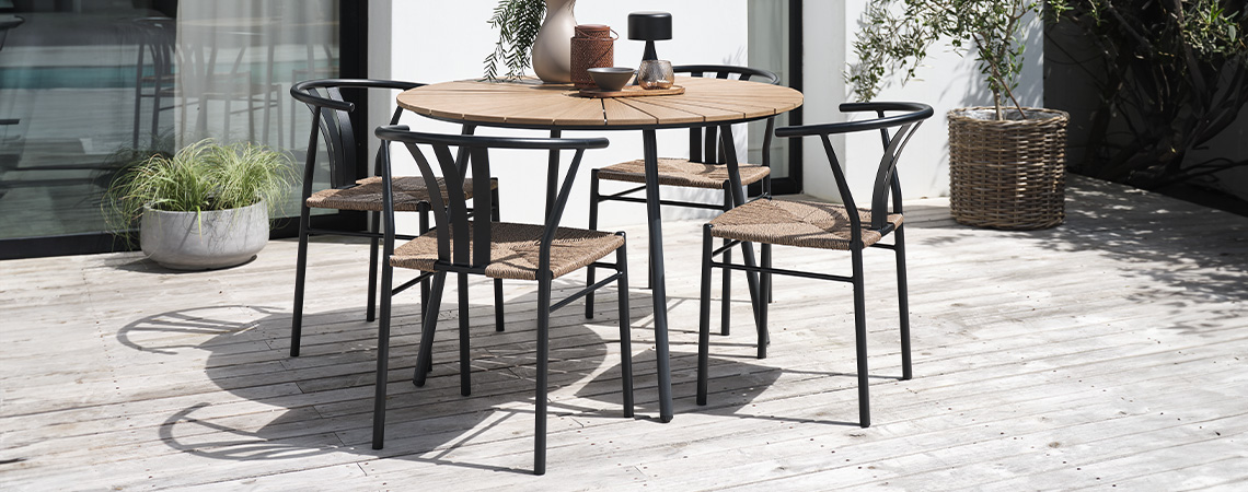 RANGSTRUP garden table and TAGMARK garden chairs Black and wooden garden table and 4 garden chairs on patio