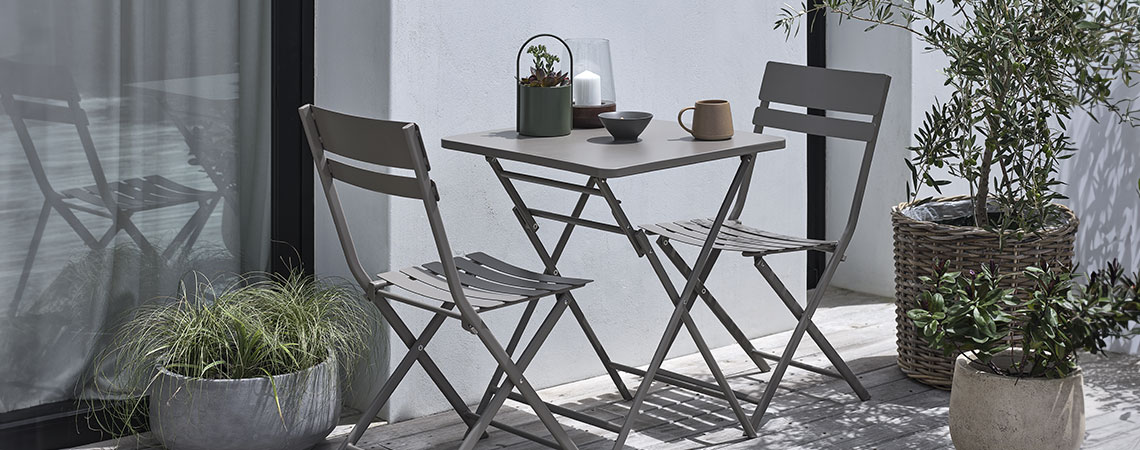 ABORG bistro set Brown bistro set on a small patio with plants and planters