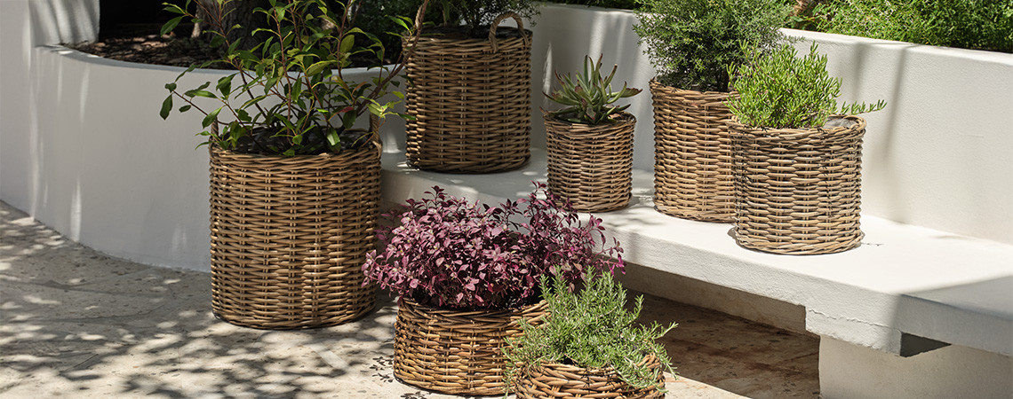 Garden planters and garden pots made from rattan in bright garden