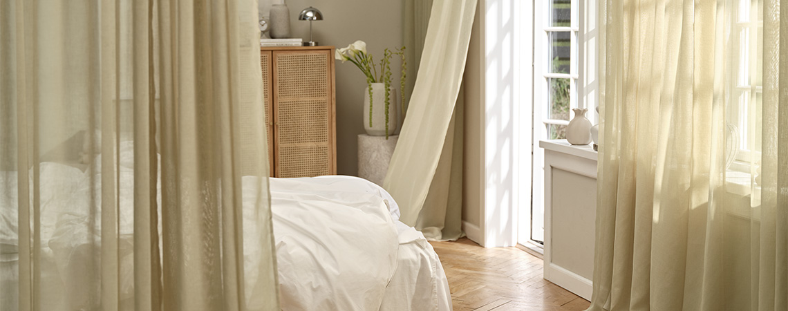 Curtains hanging on curtain rods in front of windows in dining room