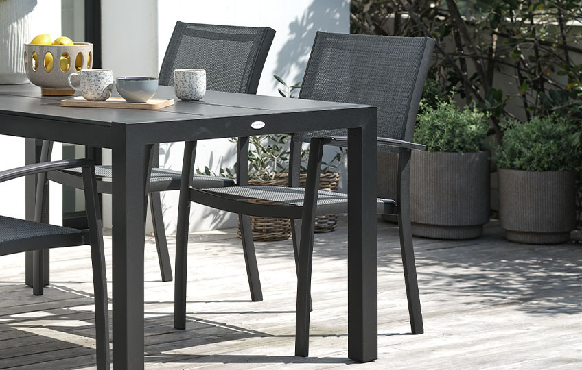 STRANDBY stacking garden chair with decorative foil covering and textiline mesh fabric Garden table and garden chairs on patio