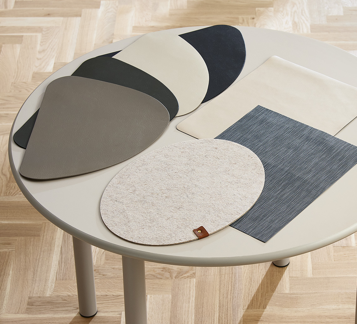 ARTISKOKK place mats in four different colours, oval KNEGRAS place mat, and beige TIDSEL place mat Round dining table with square and round place mats