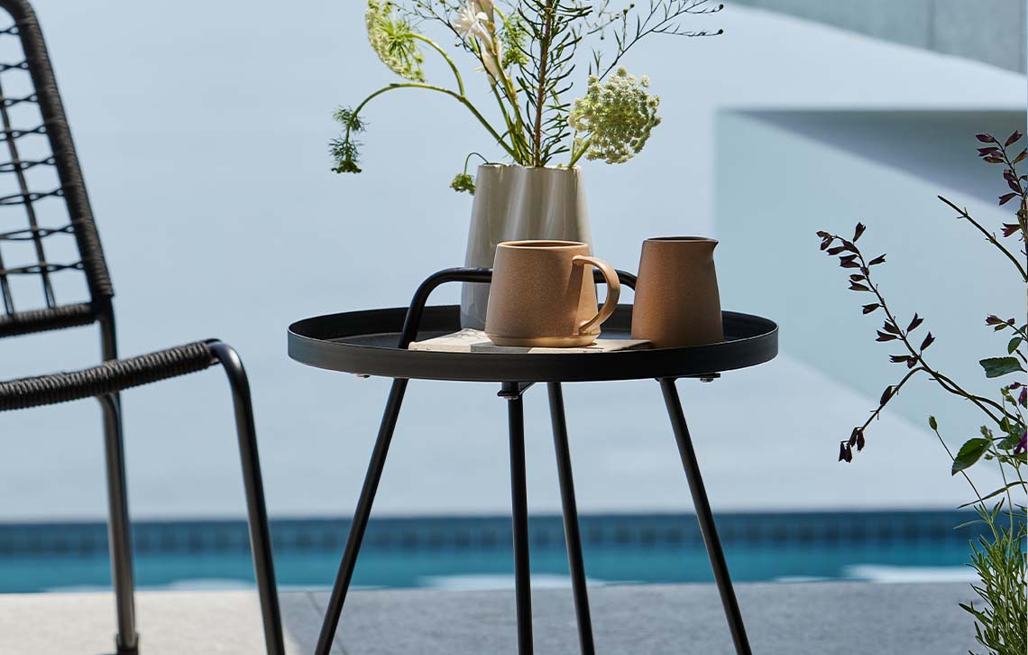 IDRE garden side table made from steel Garden side table made from steel on patio with pool