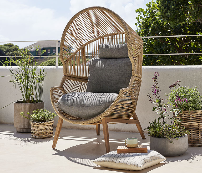 HALVREBENE lounge chair has large cushions Large lounge chair on a sunny balcony
