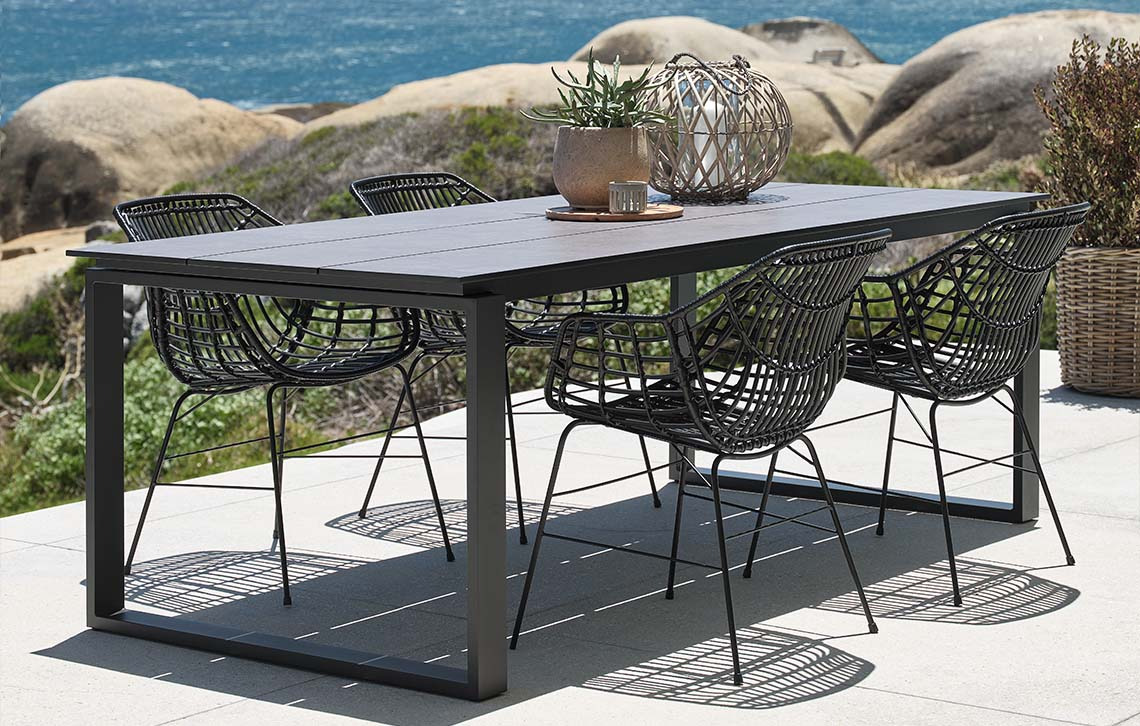 SONNERUP garden table with composite wood table top and ILDERHUSE garden chairs Garden table with table top made from composite wood and garden chairs on patio