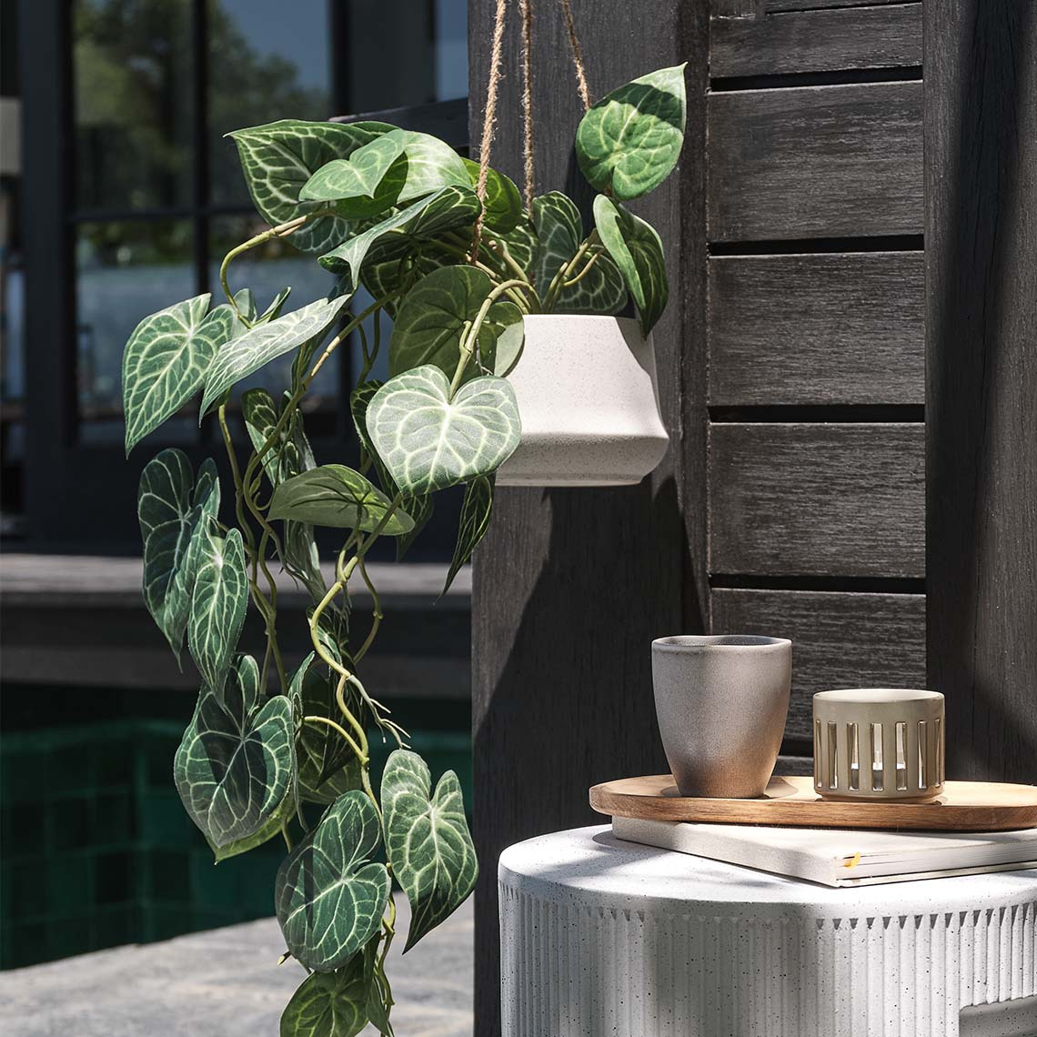 KLIPPEDUE earthenware hanging plant pot and KNOPPSVANE artificial plant Earthenware garden hanging plant pot with artificial plant on an outdoor patio