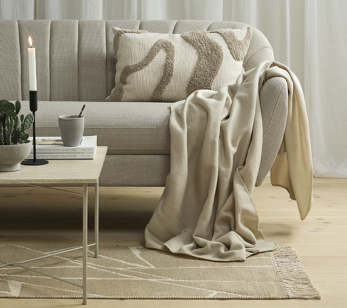 Sofa with throw and tufted cushion 