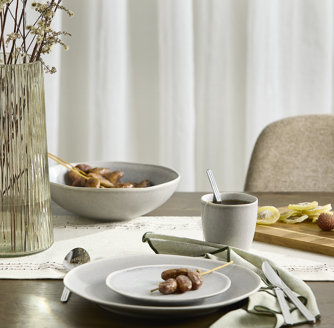 Bowls, plates, a mug and a vase on a dining table 