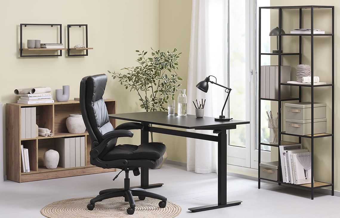 Office chair with a high back, standing desk and shelving units in a home office 