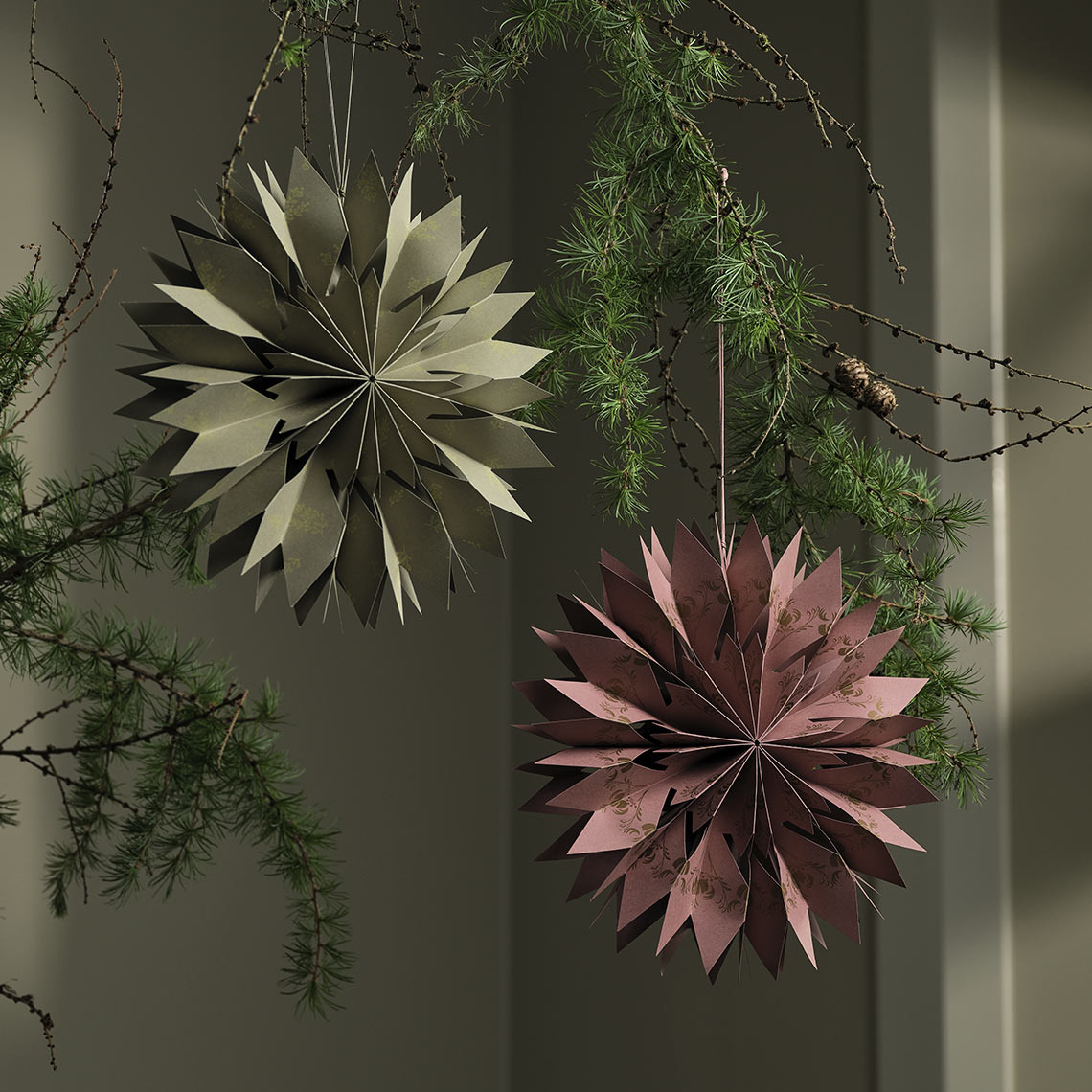 Christmas stars hanging from a branch 
