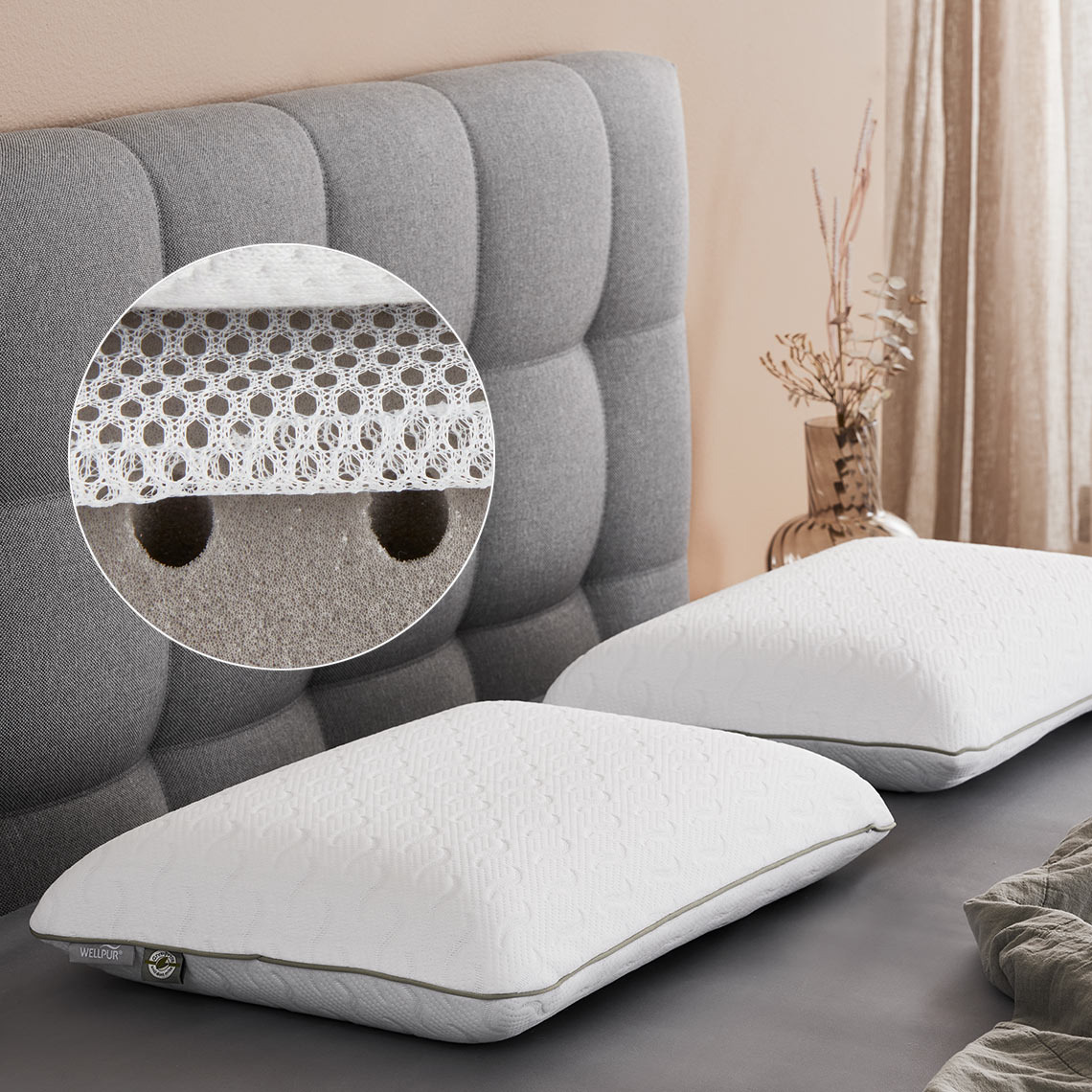 Two memory pillows on a bed with punch holes in the filling