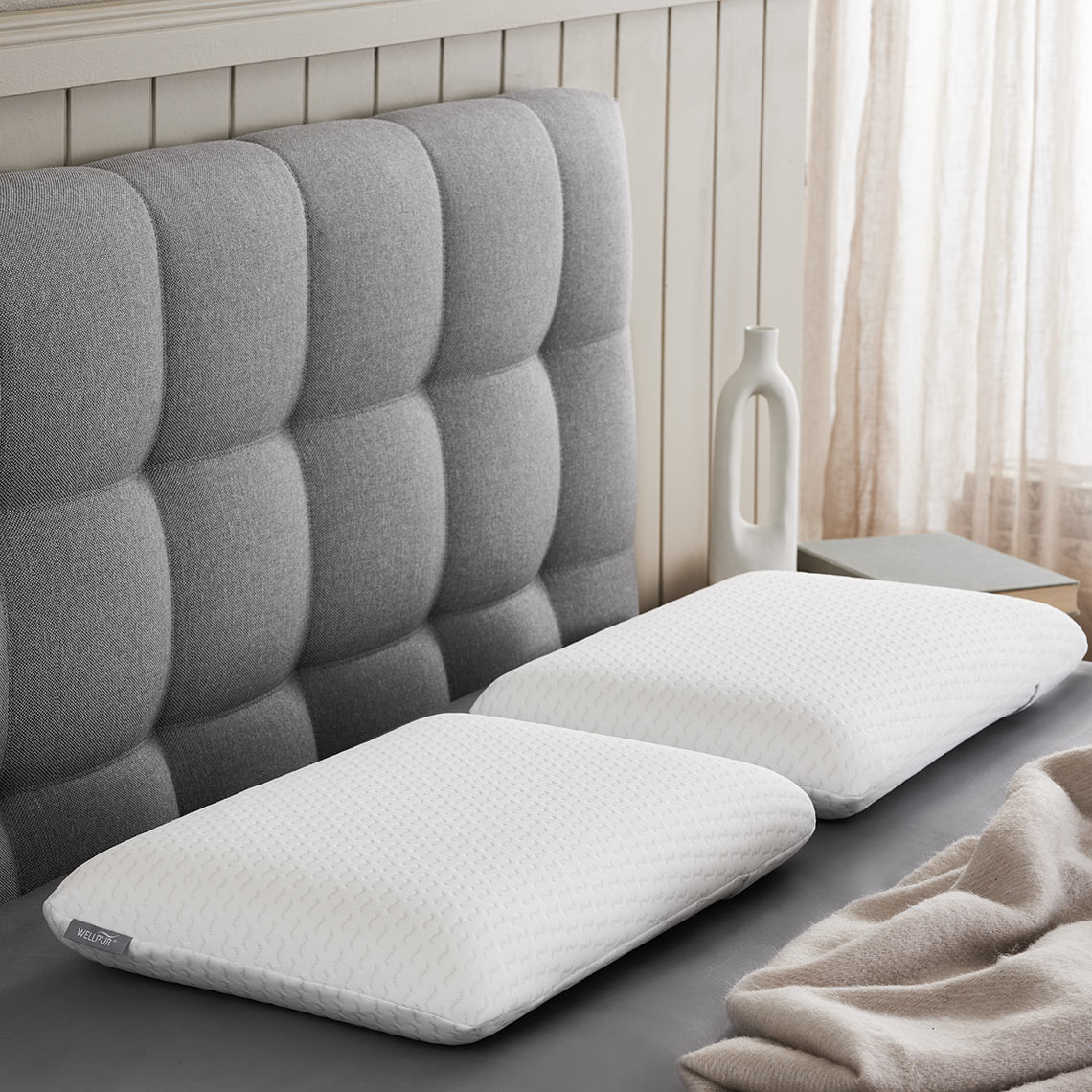 Two memory foam pillows on a bed