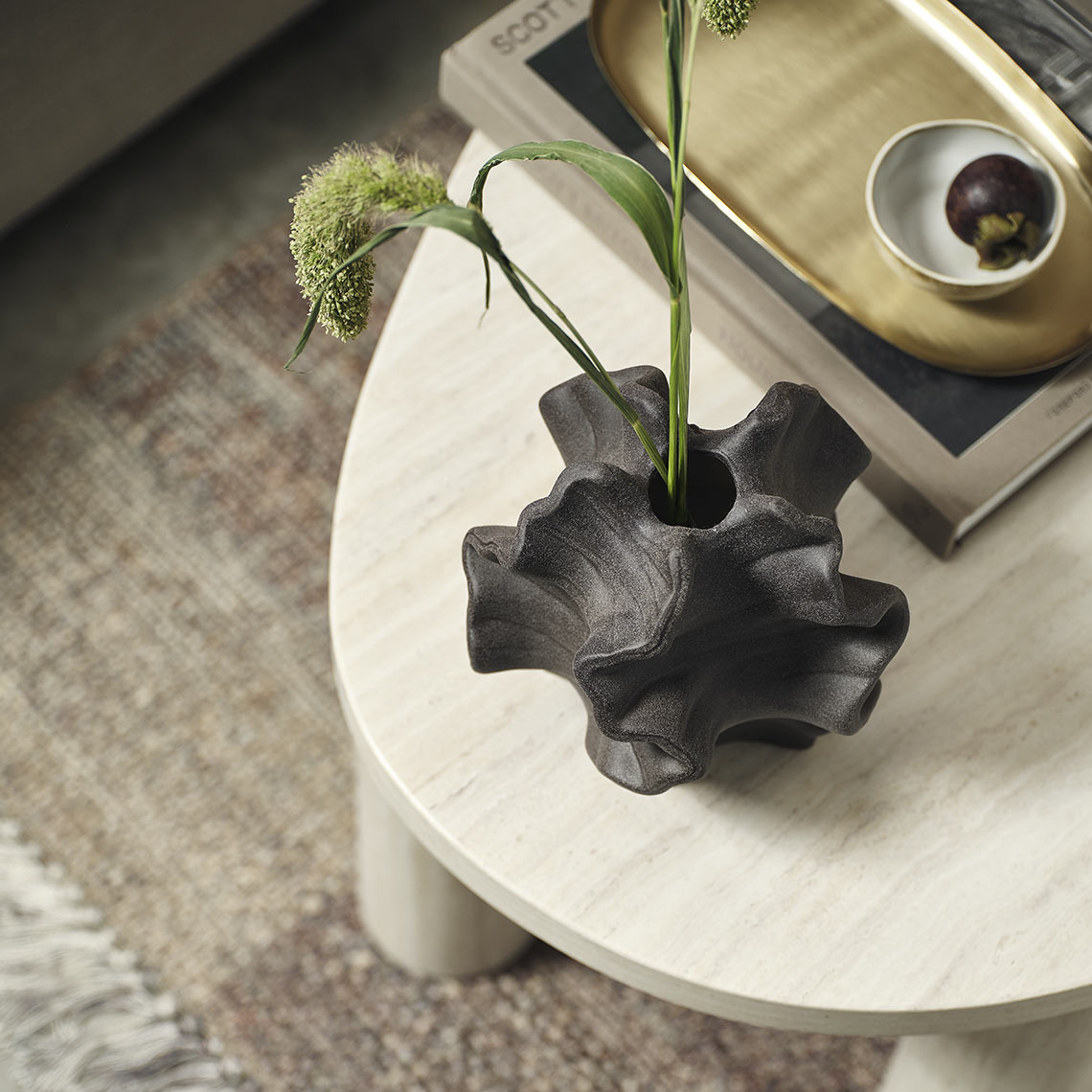 Vase with artificial flower and tray on coffee table
