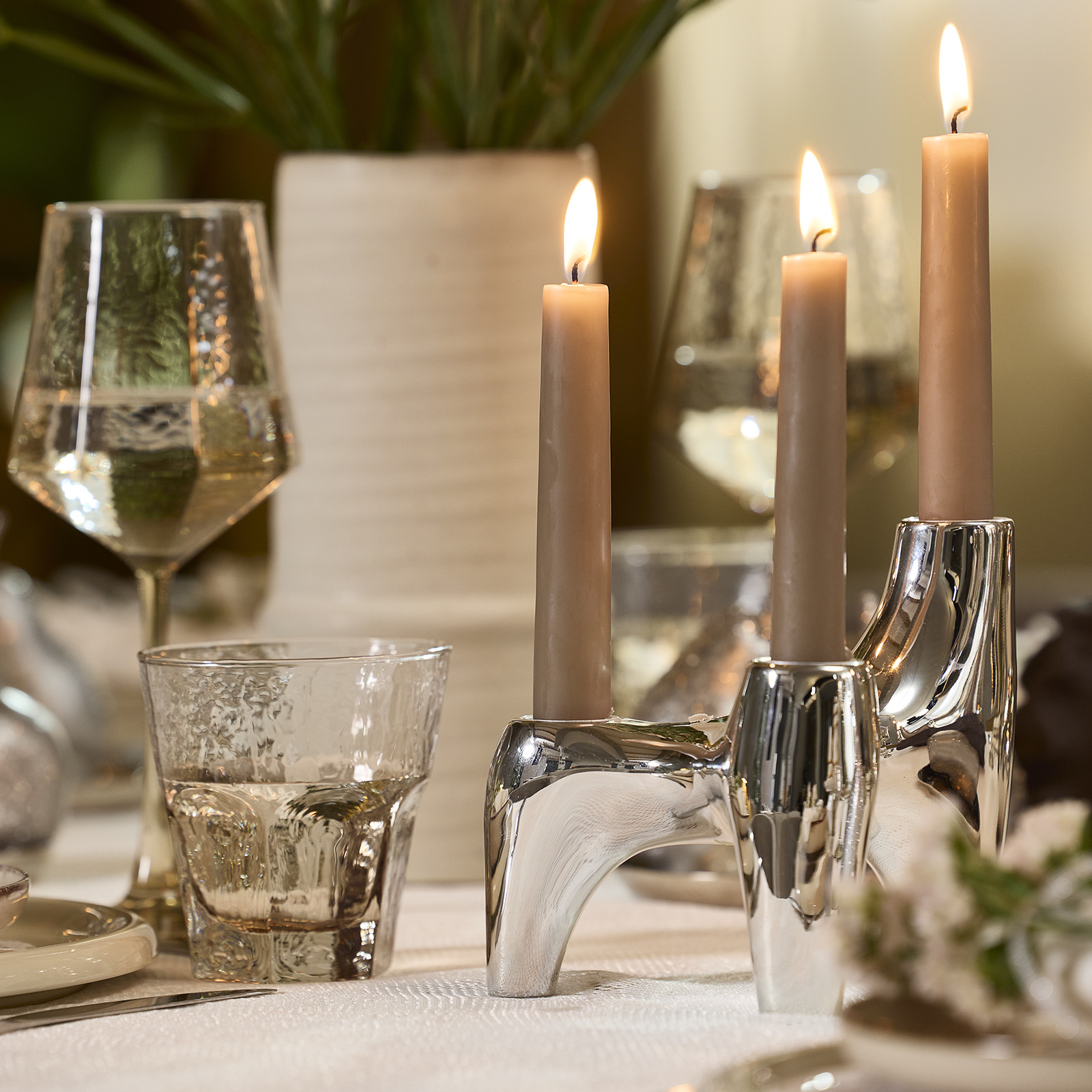 VIGNIR candlestick and GUNVALD glasses Dinner table with candlestick in a silver colour