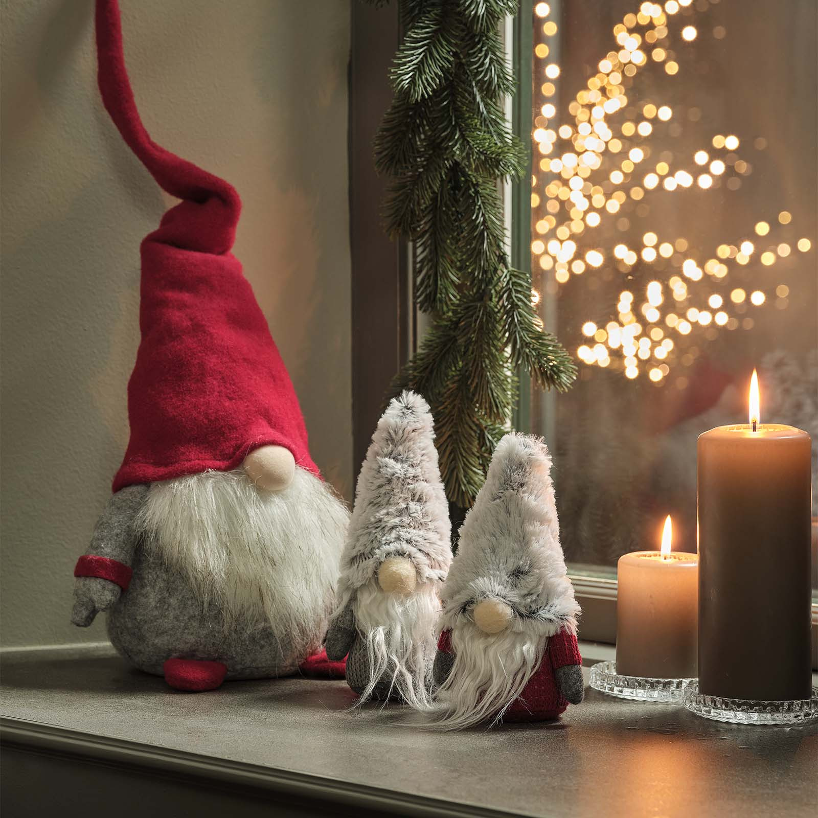 Scandinavian Christmas elves with button noses, white beards, and red and grey hats