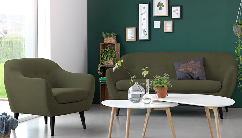 The new EGEDAL sofa and armchair in green velvet and two LEJRE coffee tables A living room with a green velvet sofa and armchair a two coffee tables