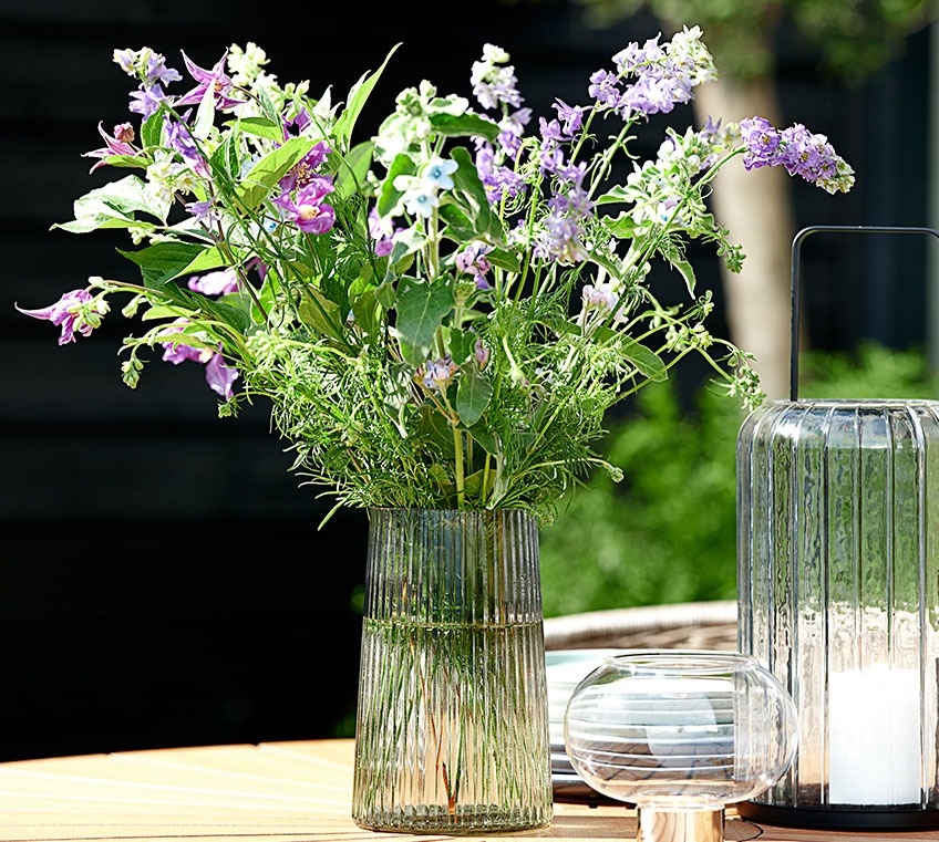 ROY glass vase on a garden table Glass vase on a garden table