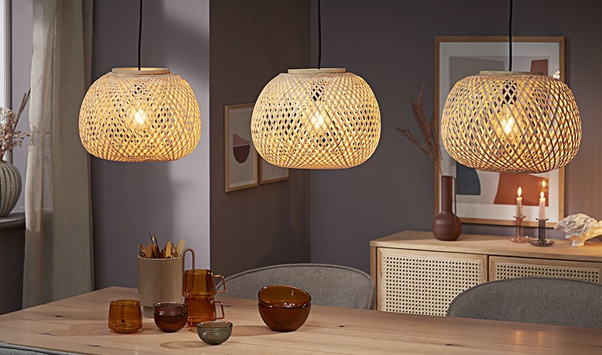 SIGVARD pendants in bamboo Three bamboo pendants hanging over dining table