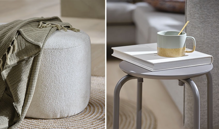 Off-white pouffe with green throw and grey stool with book and mug