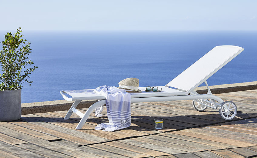 HANSTHOLM sun lounger White sun lounger with wheels by the ocean