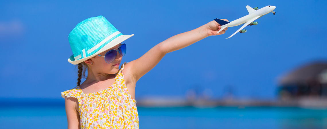 Girl holding toy airplane in the air Girl holding toy airplane in the air