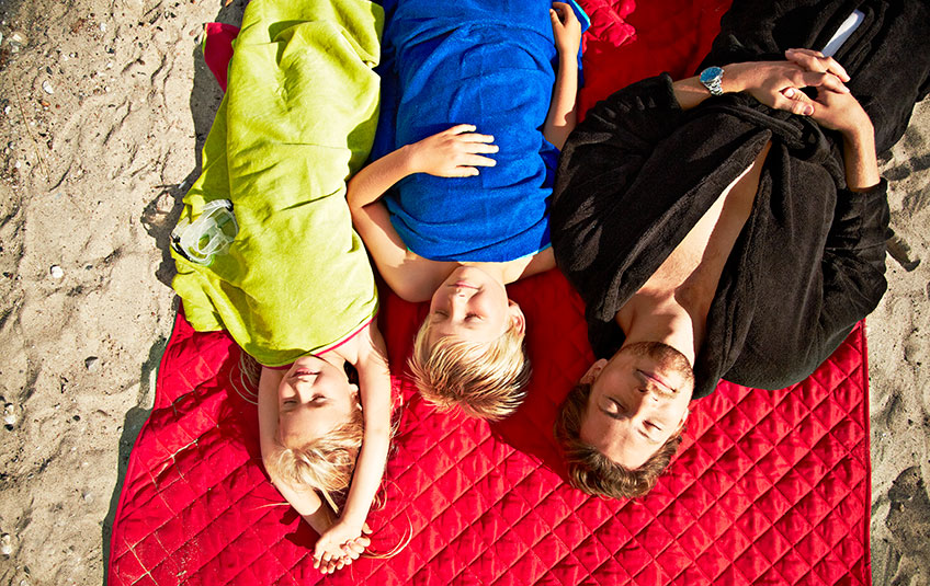 Family relaxing on the beach Family relaxing on the beach